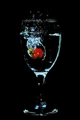 splash of water from a glass due to throwing a grape