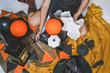 Halloween holiday. DIY making decor for Halloween. Quarantine and covid19, remote holiday, stay at home, halloween background dark,handmade,selective focus film grain