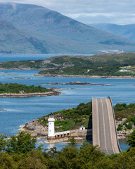 The Skye Bridge is a road bridge over Loch Alsh, Scotland, connecting the Isle of Skye to the island of Eilean Bàn and onto the mainland. Kyleakin Lighthouse can also be seen on the island