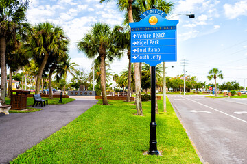 Venice, Florida retirement city at Gulf of Mexico with palm trees on street road with information...