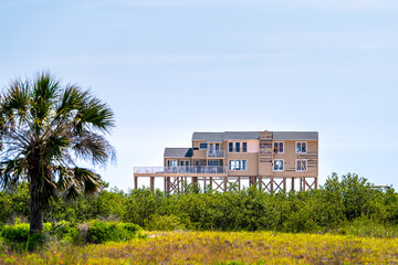 One brown stilted vacation houses on stilts at oceanfront waterfront of Atlantic ocean beach at Palm Coast, Florida damaged damage after hurricane Irma