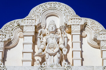 Hindu god Shiva carving displayed on the traditionalwall of a Hindu temples