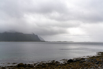 mystical fjord and Atlantic ocean on a cloudy and foggy summer day in the Lofoten Islands of northern Norway