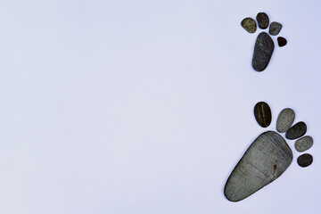 Small stone arrangement frame in the shape of a human foot