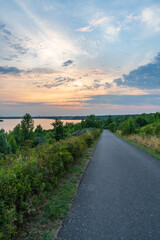 Road at the Markkleeberger lake at sunset in summer