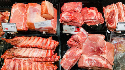 Large chunks of fresh steaks and other meat products at the farmers market. Rich selection of meal cooking for dinner and meat high protein dinner concept