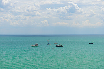 Several boats and boats on a sunny summer day at sea