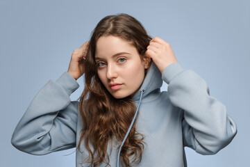 Young woman with long light hair in a oversized hoodie
