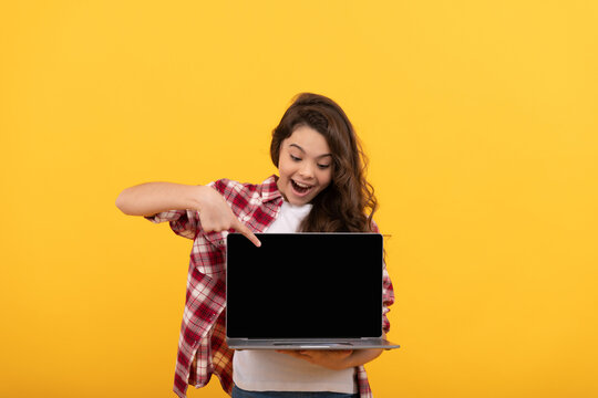 teen girl pointing finger on laptop on head. online education. back to school. webinar advertisement