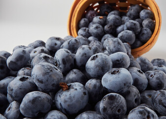 Blueberry fruit top view isolated on a white background, flat lay overhead layout with mint leaf, healthy design concept.