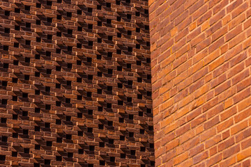 Pattern of red bricks on a wall.