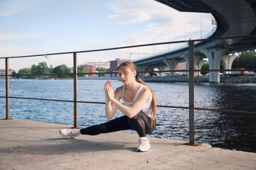 Young woman doing stretching before training
