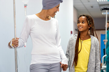 Fototapeta premium Sick woman with cancer hugging her young grandchild in hospital. Family support concept.