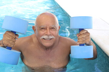 Senior man holding dumbbells in swimming pool