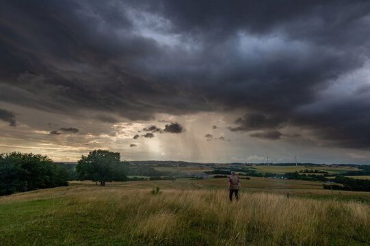 Dark sky and dramatic black cloud before rainy, man in the foreground
