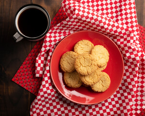 Flat lay image of Homemade crunchy cookies and a coffee cup on wooden rustic table
