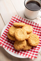 Homemade crunchy cookies and a coffee cup on wooden rustic table