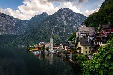 Fototapeta na wymiar Scenic panoramic view of famous Hallstatt lakeside town reflecting in Hallstattersee lake in the Austrian Alps in scenic morning light on a beautiful sunny day in summer, Salzkammergut region, Austria