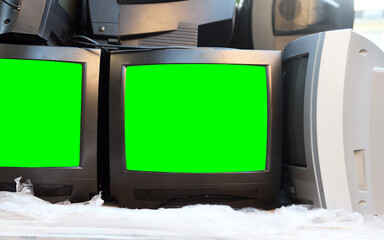 Dump of old CRT TVs with green screens for adding video and images. Vintage TVs 1980s 1990s 2000s. 