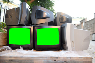 Dump of old CRT TVs with green screens for adding video and images. Vintage TVs 1980s 1990s 2000s. 