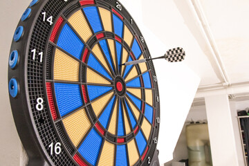 Close-up shot of a dart stuck in the number twenty of a dartboard - concept of a loser