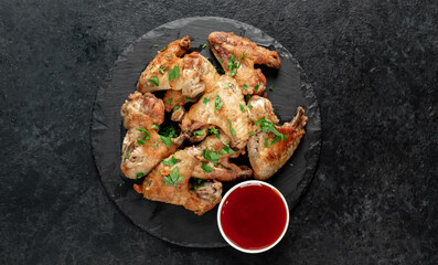 grilled chicken wings on stone background