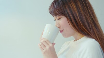 Portrait of young beautiful woman having a cup of coffee