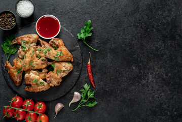 grilled chicken wings on stone background with copy space for your text