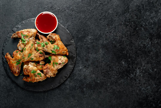 grilled chicken wings on stone background with copy space for your text