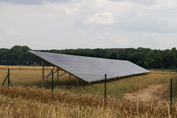 Solar panels and golden wheat field in summer. ripe ear before harvest