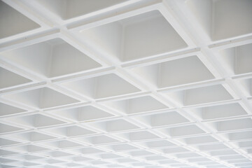  White concrete ceiling in squares in the building. Detail of the roof structure of modern building.