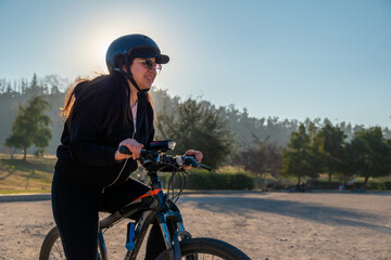 Young woman riding a bike at an urban park