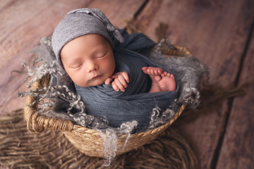 Sleeping newborn boy in the first days of life. Newborn photo session.