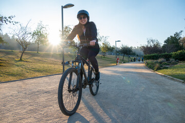 Young woman riding a bike at an urban park