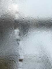 view from the window wet glass covered with wet flowing water, snow melts