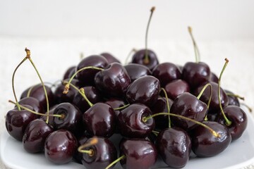 Ripe red cherries fruit macro isolated on the plate. Slovakia