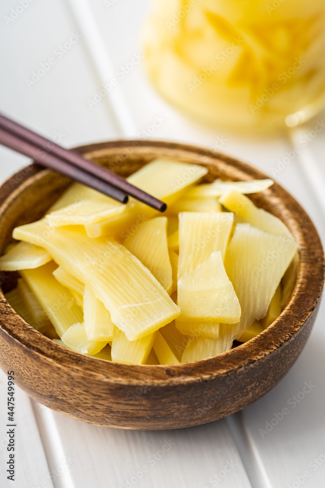 Sticker Sliced canned bamboo shoots in wooden bowl.