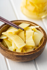 Sliced canned bamboo shoots in wooden bowl.
