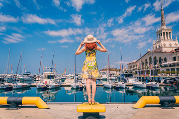 Girl is looking at the yachts in the Marine Station in Sochi. Summer Vacation. Destination.
