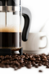 Coffee maker closeup with white coffee mug on background