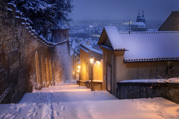 Stairs leading to the Prague Castle covered with snow.