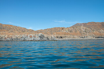 Seascape, mountain by the sea of cortes in the Baja peninsula at Loreto in the state of Baja California Sur. Mexico with blue sky and sunny summer day, vacations, and travel concept.