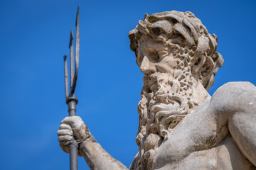 The mighty god of the sea and oceans Neptune (Poseidon) against blue background. Close up ancient...