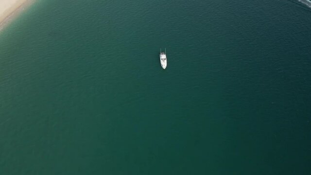 A lonely yacht drifts near the shore Mexico Cabo