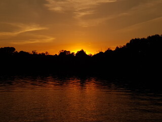 Naklejka premium sunset over the river