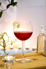 Spa-beauty salon, wellness center. Spa treatment aromatherapy for the female body in the bathroom with a glass of wine, with candles, oils and salt