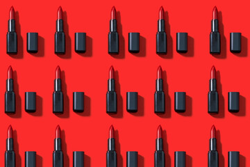 Creative pattern fashion photo of cosmetics beauty products red lipstick on a red background