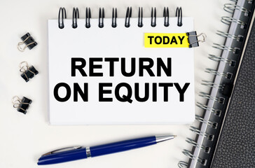On the table is a pen and a notebook with inscriptions - Today and RETURN ON EQUITY