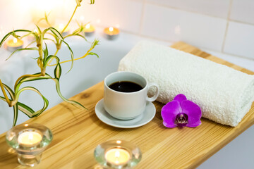 Obraz na płótnie Canvas Spa-beauty salon, wellness center. Aromatherapy spa treatment for the female body in the bathroom with a cup of coffee, candles, oils and salt.