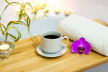 Spa-beauty salon, wellness center. Aromatherapy spa treatment for the female body in the bathroom with a cup of coffee, candles, oils and salt.